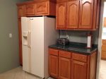 Other side of kithen with side by side refrigerator and ice maker.  Lots of cabinet space for your supplies.